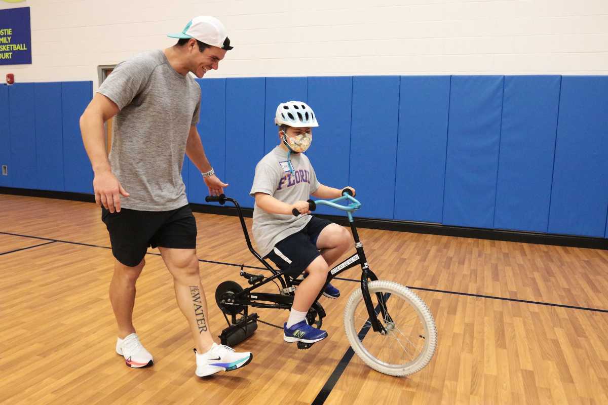 Jacksonville Jaguars kicker Josh Lambo(left) guides 10-year-old Drew Crass, during Tuesday's IBike Camp at the North Florida School of Special Education. Lambo sponsors the camp's first appearance in Jacksonville, and helped in sessions. © Lawren Simmons/Florida Times-Union